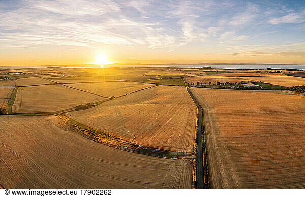 UK  Scotland  Aerial view of harvested barley fields at summer sunset