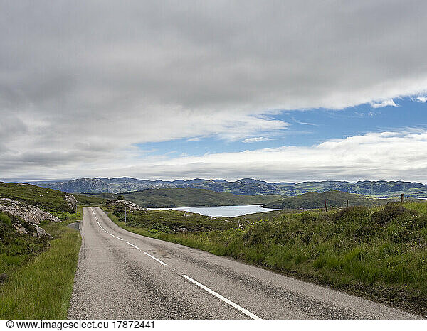 UK  Scotland  Clouds over empty asphalt road in Northwest Highlands