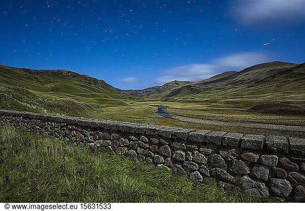 UK  Scotland  Glenshee  landscape with stone wall under starry sky