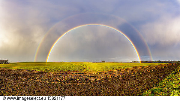UK  Scotland  Panorama of double rainbow over agricultural field