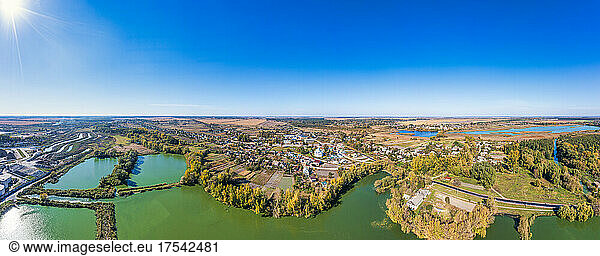 Ukraine  Zhytomyr Oblast  Chervone  Aerial panorama of lakeshore town on sunny autumn day