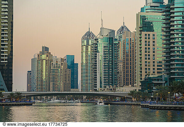United Arab Emirates  Dubai  Dubai Marina at dusk with bridge and tall downtown skyscrapers in background