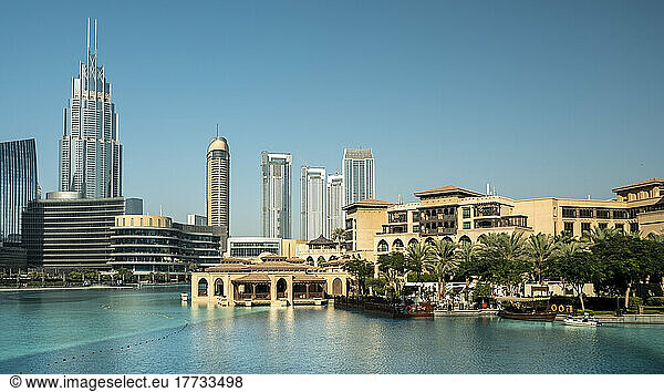 United Arab Emirates  Dubai  Panoramic view of Burj Khalifa Lake in summer with luxury hotels  shopping malls and skyscrapers in background