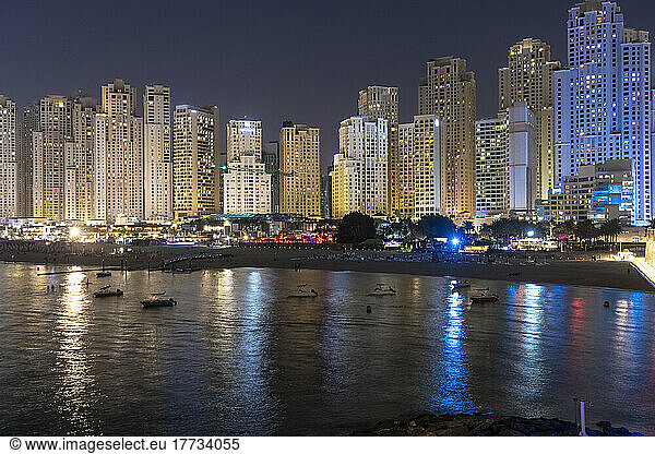 United Arab Emirates  Dubai  Skyline of illuminated coastal apartments at night