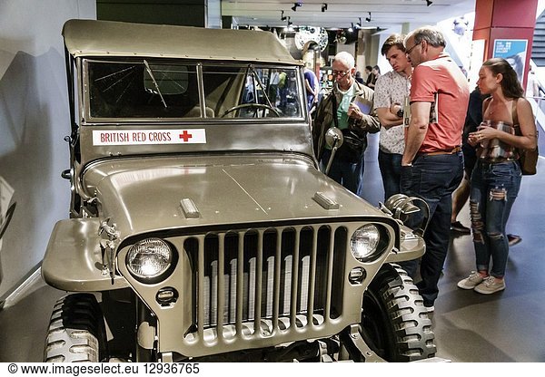 United Kingdom Great Britain England  London  Southwark  Imperial War Museum  military war weapons archives  inside  interior  exhibit  British Red Cross  jeep  Willys MB Jeep 4x4  Second World War  man  woman  looking