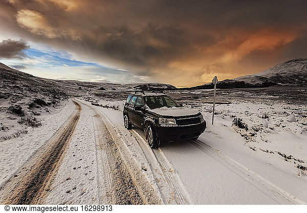 United Kingdom  Scotland  Isle of Skye  off-road vehicle at sundown in winter