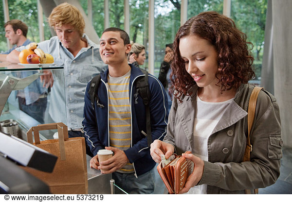 University student paying in college cafe