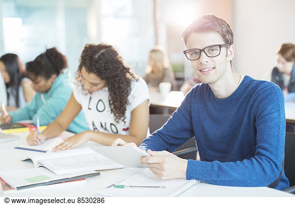 University student using digital tablet in classroom