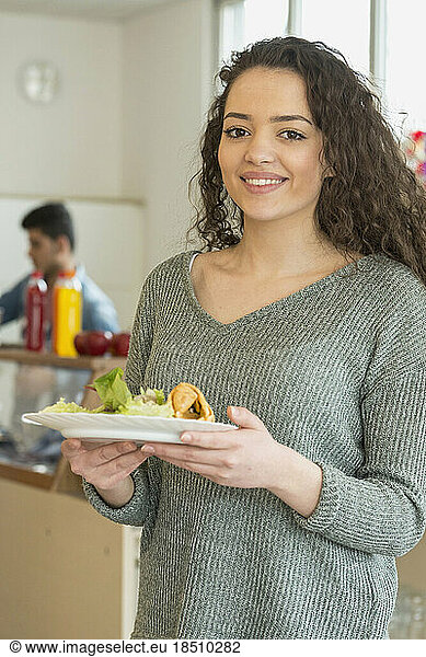 University student with her lunch in plate and smiling School  Bavaria  Germany