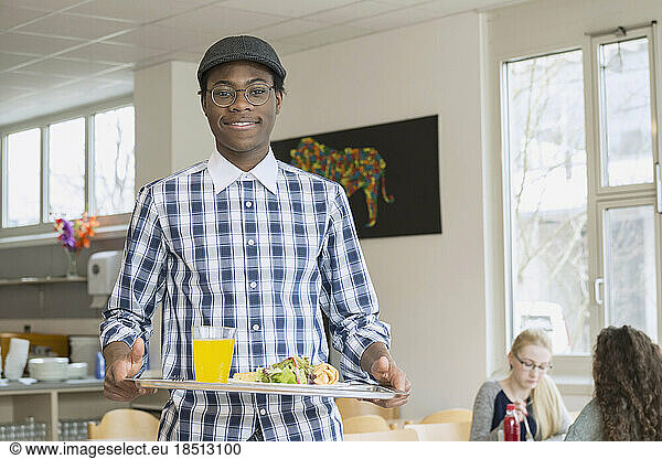 University student with his lunch in plate and smiling School  Bavaria  Germany