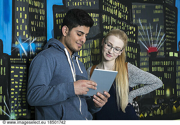 University students with digital tablet in front of graffiti wall School  Bavaria  Germany