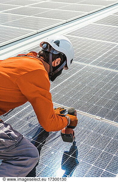 Unrecognizable solar panel technician working in Spanish installation