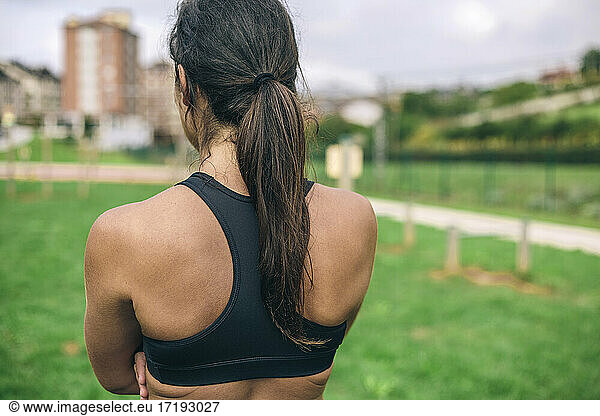Unrecognizable young sportswoman training outdoors