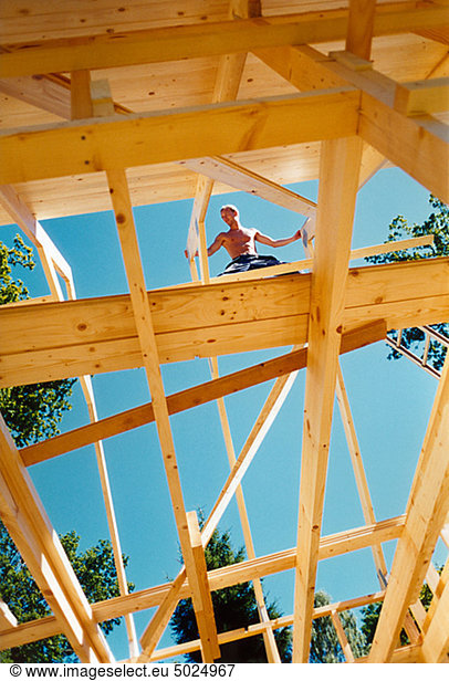 Upward view of man on construction site
