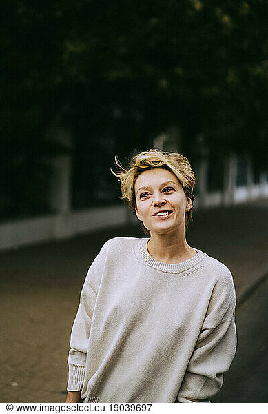 Urban romantic portrait of a young woman with short hair.