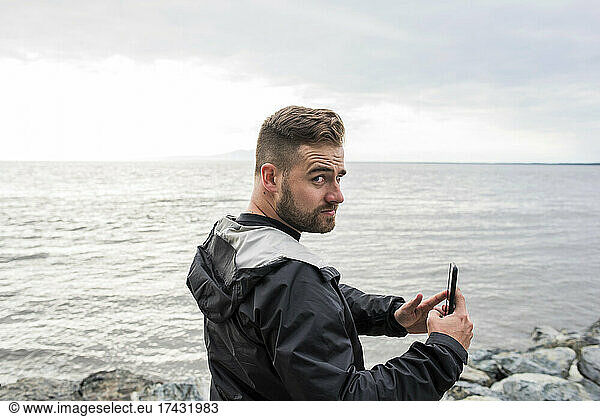 USA  Alaska  Man with smart phone in Kenai Fjords National Park