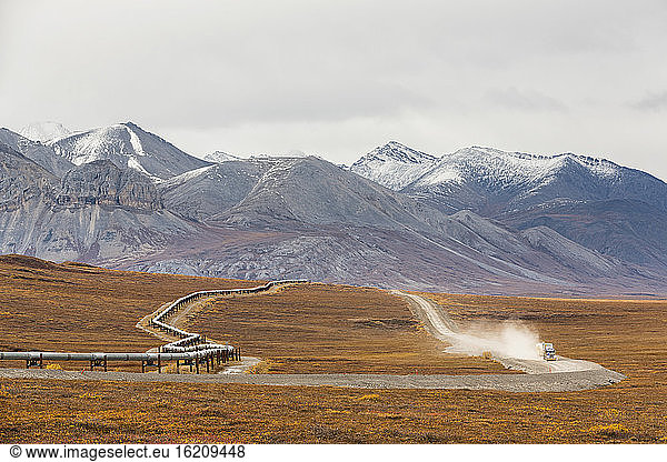 USA  Alaska  View of Trans Alaska Pipeline System along Dalton Highway with truck in autumn and Brooks Range
