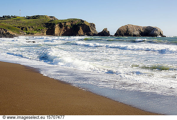 USA  California  San Francisco  Waves brushing sandy coastal beach of Marin Headlands