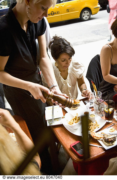 USA  New York State  Waitress serving customers at Cinema Restaurant  New York City