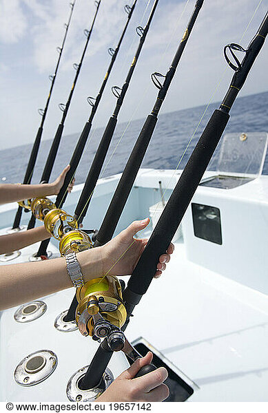Vacationer's are poised for action as the hold their deep sea fishing rods.