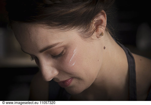 Valentine's Day baking  close up portrait of a young woman with flour on her cheek.