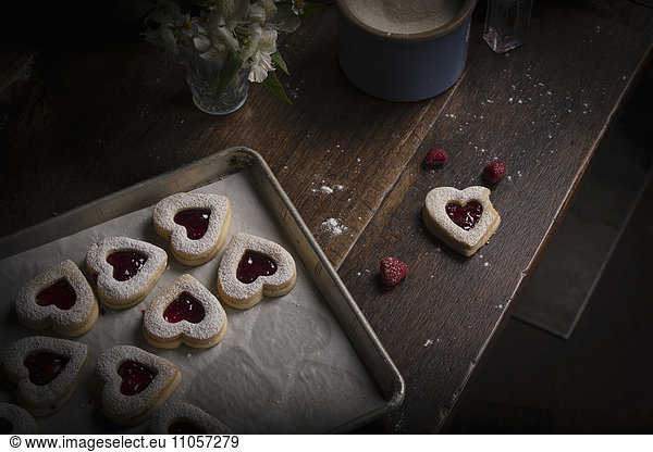 Valentine's Day baking  high angle view of a baking tray with heart shaped biscuits.