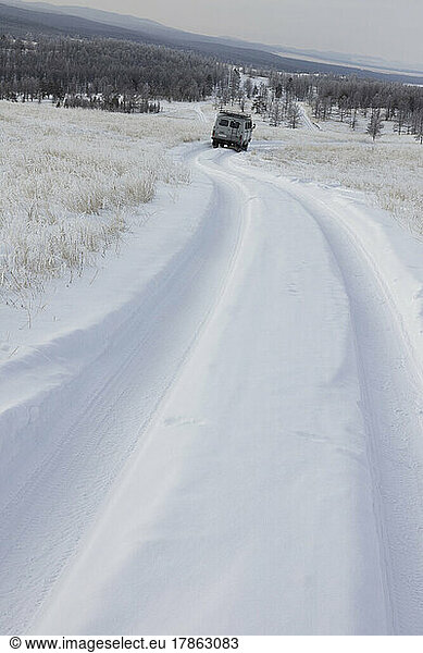 van going down icy and frozen road