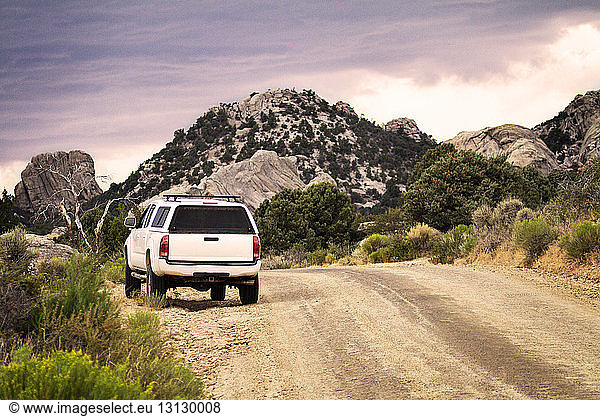 Van parked on dirt road by mountains