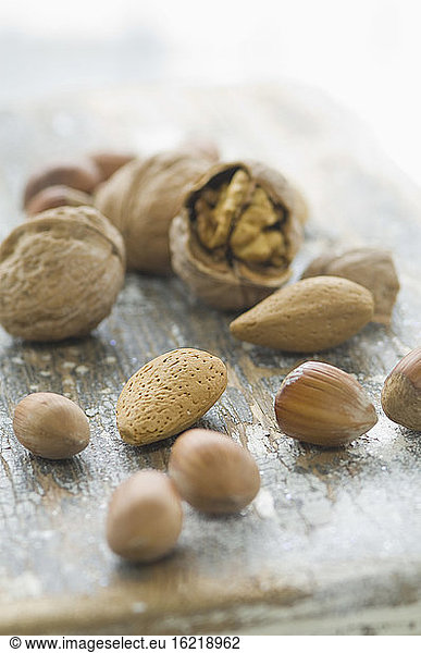 Variety of nuts on wooden table  close up