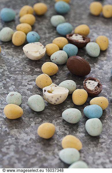 Various chocolate eggs on a textured surface
