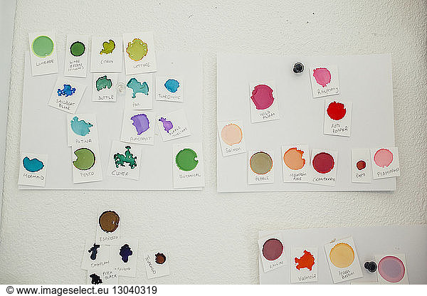 Various color samples with text hanging on wall