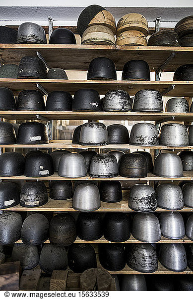 Various hat shaped equipment on shelves in workshop