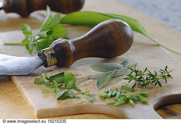 Various herbs on chopping board