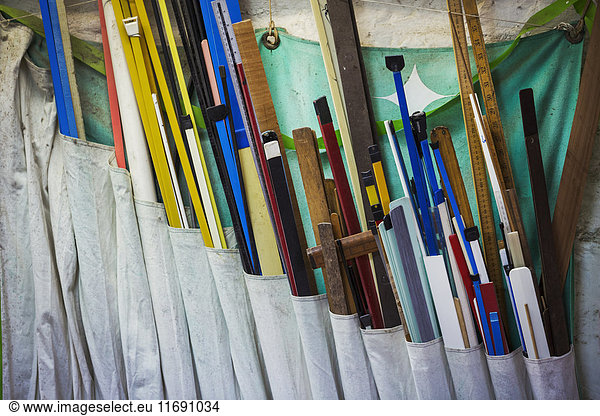 Various length of wood in different colours in a sailmaker's workshop.