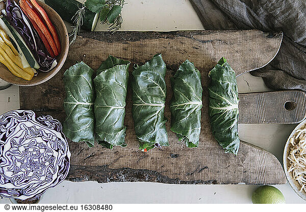 Vegan rolls with vegetables on cutting board