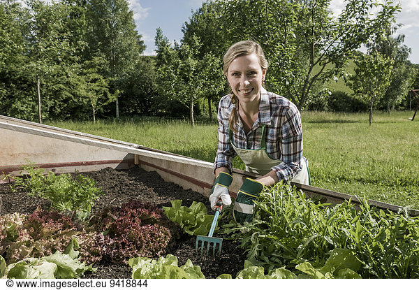 Vegetable garden woman working hoe
