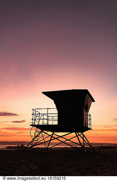 Vertical shot of a lifeguard tower at sunset in California