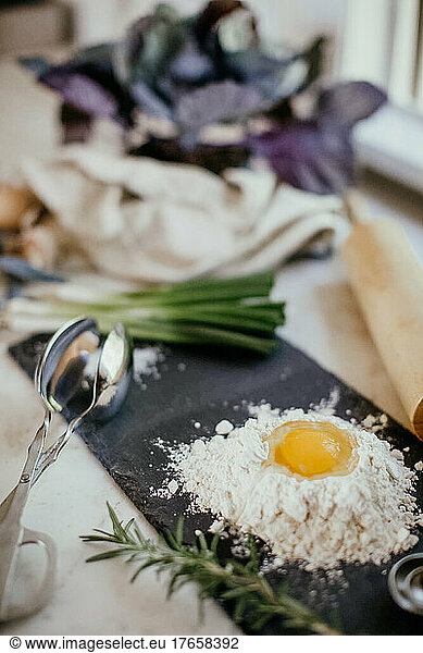 Vertical Shot of Eggs with Flour on Kitchen Counter
