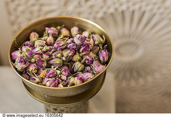 Vessel of dried rose blossoms