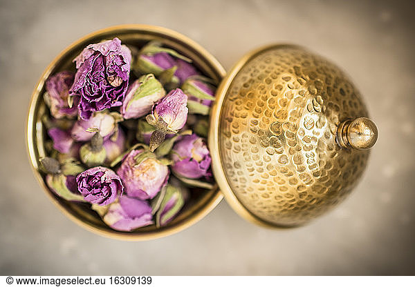 Vessel of dried rose blossoms