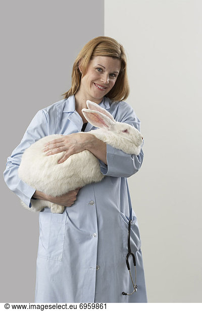 Veterinarian Holding Giant Rabbit