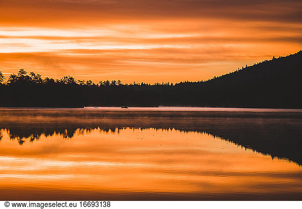 vibrant sunrise and reflection  Togue Pond  Baxter State Park  maine
