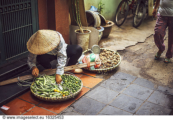 Vietnam  female street vendor with vegetables
