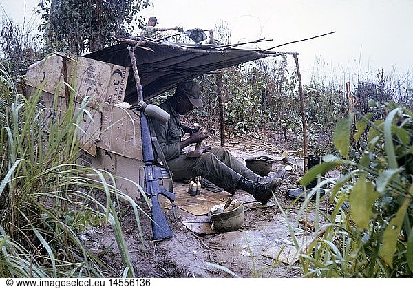 Vietnam War 1957 - 1975  American soldier in a improvised hut is cleaning a M79 grenade launcher  South Vietnam  1965  paperboard  African-American  African-Americans  steel helmet  steel helmets  weapons  arms  weapon  arm  assault rifle M16  automatic rifle  assault rifle  rifles  ammunition  shell  grenade  shells  grenades  military  armed forces  army  armies  USA  United States of America  South-East Asia  South East Asia  Southeast Asia  Far East  Viet Nam conflict  Viet Nam  Vietnam  war  wars  conflict  conflicts  1960s  60s  20th century  people  man  men  male  soldier  soldiers  hut  huts  historic  historical  water bottle  water bottles  canteen  cleansing  cleanup  cleaning  clean