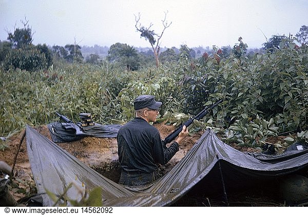 Vietnam War 1957 - 1975  American soldier on picket  position after a rain  South Vietnam  1965  moist  moisty  moister  moistest  wet  dampness  wetness  post  foxhole  foxholes  tent blanket  weapons  arms  weapon  arm  assault rifle M16  automatic rifle  assault rifle  rifles  bayonet  bayonets  ammunition  magazine  magazines  military  armed forces  army  armies  USA  United States of America  South-East Asia  South East Asia  Southeast Asia  Far East  Viet Nam conflict  Viet Nam  Vietnam  war  wars  conflict  conflicts  1960s  60s  20th century  people  man  men  male  soldier  soldiers  position  positions  historic  historical