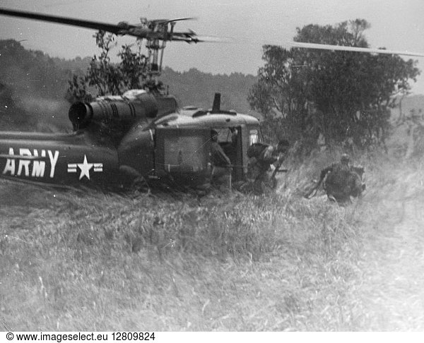 VIETNAM WAR: HELICOPTER. U.S.Army soldiers debark from a UH-1B helicopter in central South Vietnam  n.d.
