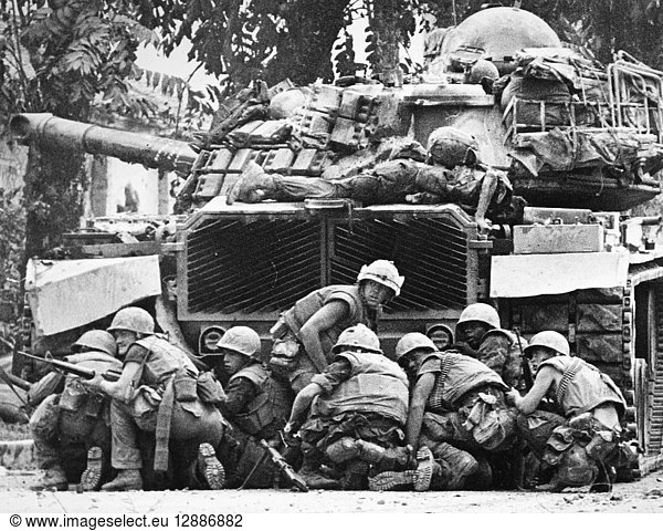 VIETNAM WAR: TET OFFENSIVE. U.S. Marines take cover from sniper fire during the Battle of Hue  1 February 1968.