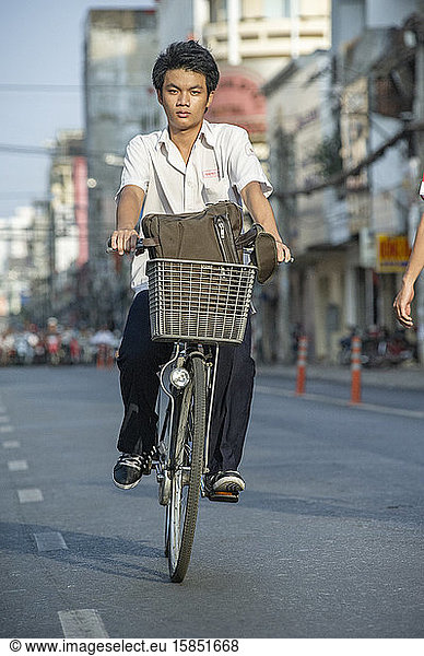 Vietnamese student cycling in the streets