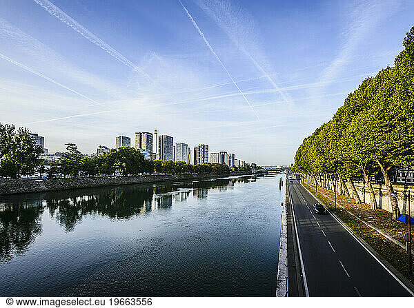 View along the River Seine  a road by the water  high rise buildings.