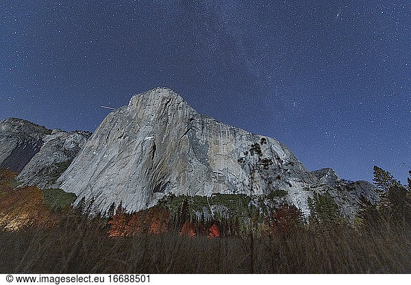 View at night of climbers on El Capitan climbing under the stars